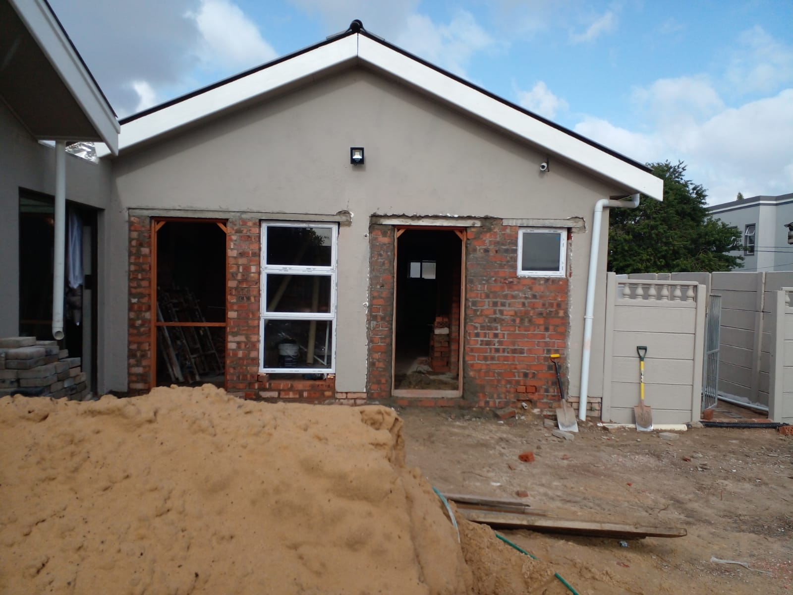 Home addition with new brick window and door openings